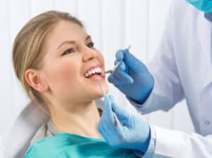 A woman being treated for tooth decay at the dentist’s office